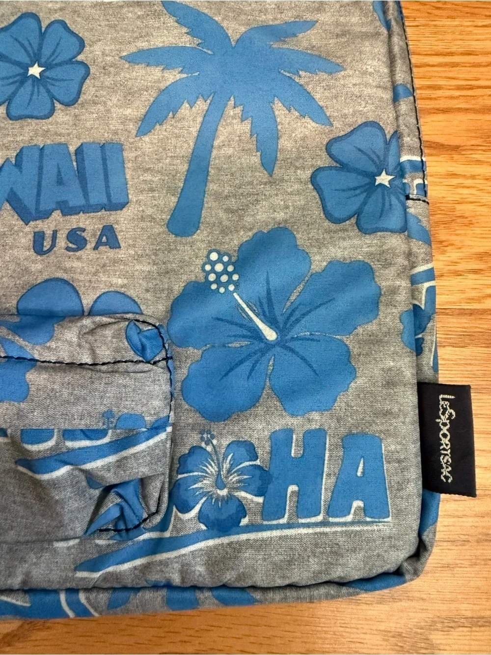LeSportsac brand travel pouch or laptop case featuring a blue and grey hibiscus